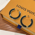 L V blk/gold earrings